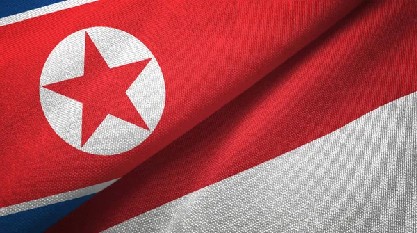 North Korea and Indonesia two flags textile cloth, fabric texture — Stock Photo, Image