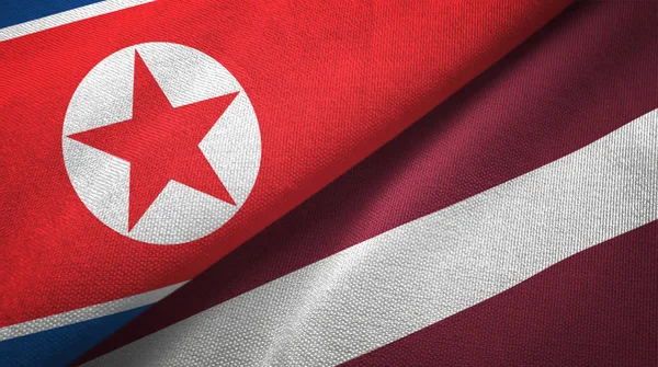 North Korea and Latvia two flags textile cloth, fabric texture — Stock Photo, Image