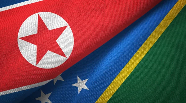 North Korea and Solomon Islands two flags textile cloth, fabric texture