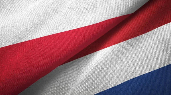 Polonya ve Hollanda iki bayraklar tekstil kumaş, kumaş dokusu — Stok fotoğraf