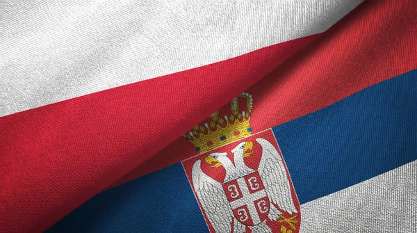 Polsko a Srbsko dvě vlajky textilní tkaniny, textura textilií — Stock fotografie