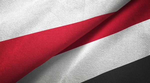 Polsko a Jemen dvě vlajky textilní tkaniny, textura textilií — Stock fotografie