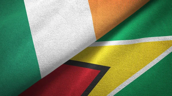 Irlanda y Guyana dos banderas tela textil, textura de la tela — Foto de Stock