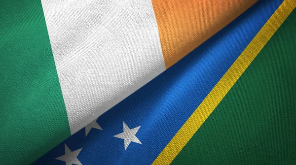 Ireland and Solomon Islands two flags textile cloth, fabric texture