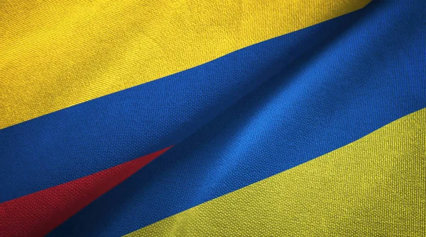 Colômbia e Ucrânia duas bandeiras de pano têxtil, textura de tecido — Fotografia de Stock