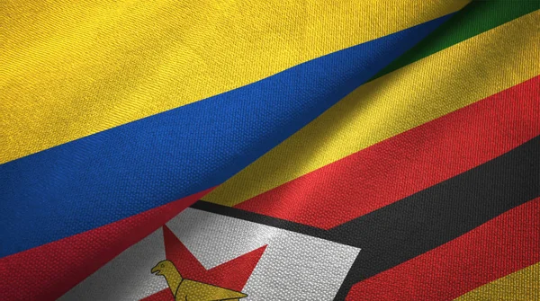 Colombia en Zimbabwe twee vlaggen textiel doek, weefsel textuur — Stockfoto