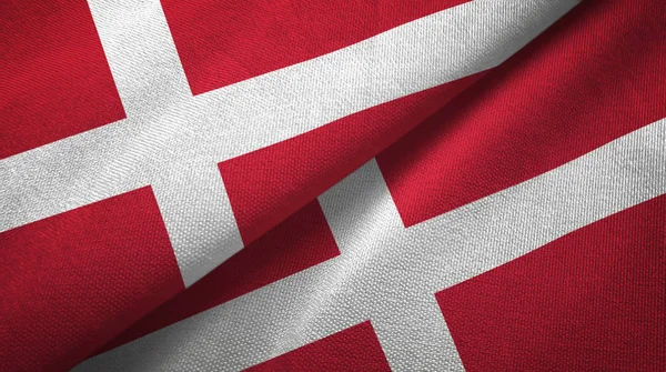 Dánia két zászló textil ruhával, szövet textúra — Stock Fotó