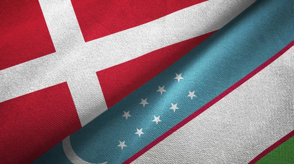 Danmark och Uzbekistan två flaggor textil tyg, tyg konsistens — Stockfoto