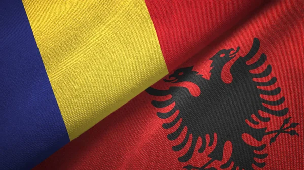 Roemenië en Albanië twee vlaggen textiel doek, weefsel textuur — Stockfoto