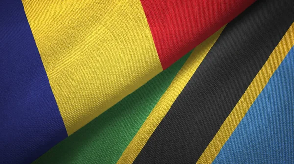 Románia és Tanzánia két zászlókat textil ruhával, szövet textúra — Stock Fotó