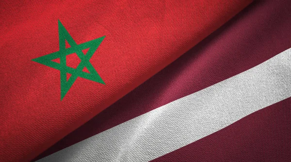 Marokko en Letland twee vlaggen textiel doek, weefsel textuur — Stockfoto