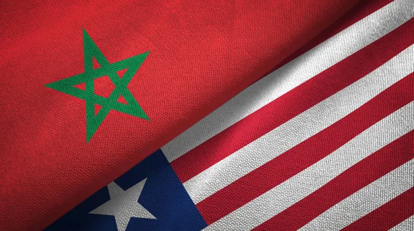 Marokko en Liberia twee vlaggen textiel doek, weefsel textuur — Stockfoto