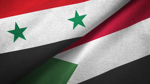 Syrien och Sudan två flaggor textil trasa, tyg konsistens — Stockfoto