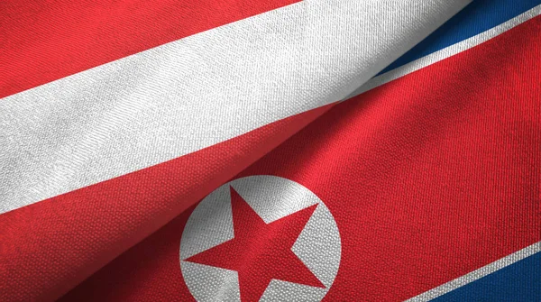 Oostenrijk en Noord-Korea twee vlaggen textiel doek, weefsel textuur — Stockfoto
