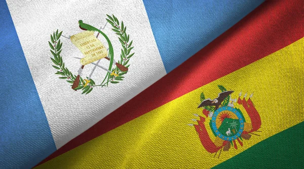 Guatemala e Bolívia duas bandeiras de pano têxtil, textura de tecido — Fotografia de Stock