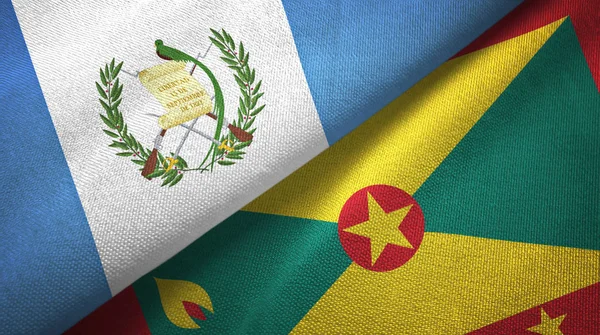 Guatemala y Granada dos banderas de tela textil, textura de tela —  Fotos de Stock
