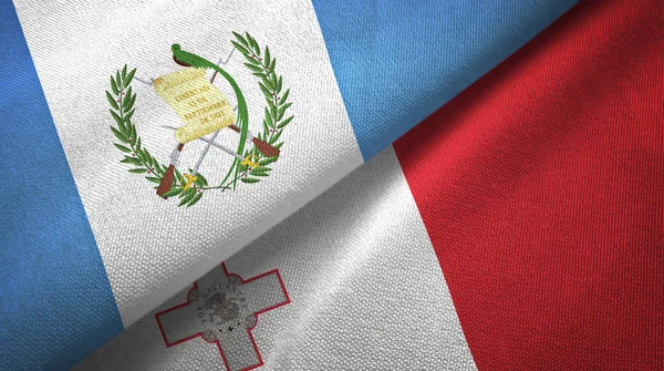 Guatemala e Malta duas bandeiras de pano têxtil, textura de tecido — Fotografia de Stock