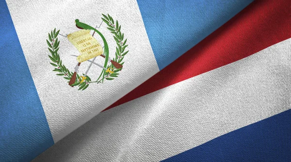 Guatemala en Nederland twee vlaggen textiel doek, stof textuur — Stockfoto