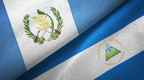 Guatemala and Nicaragua two flags textile cloth, fabric texture — Stock Photo, Image