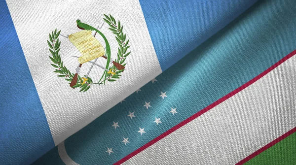 Guatemala et Ouzbékistan deux drapeaux tissu textile, texture du tissu — Photo