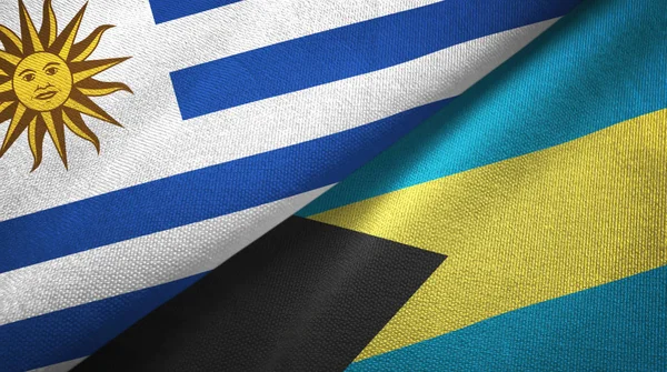 Uruguay y Bahamas dos banderas tela textil, textura de tela —  Fotos de Stock