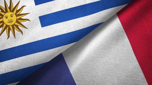 Uruguay y Francia dos banderas de tela textil, textura de tela —  Fotos de Stock