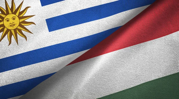 Uruguay and Hungary two flags textile cloth, fabric texture