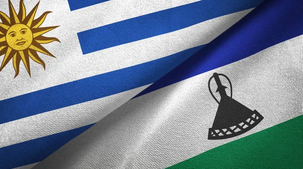 Uruguay und lesotho zwei flaggen textiltuch, textur — Stockfoto