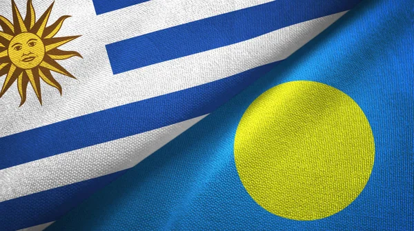 Uruguay y Palau dos banderas tela textil, textura de la tela —  Fotos de Stock