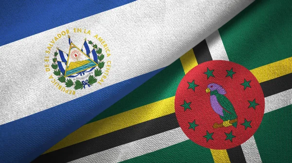 El Salvador en Dominica twee vlaggen textiel doek, weefsel textuur — Stockfoto