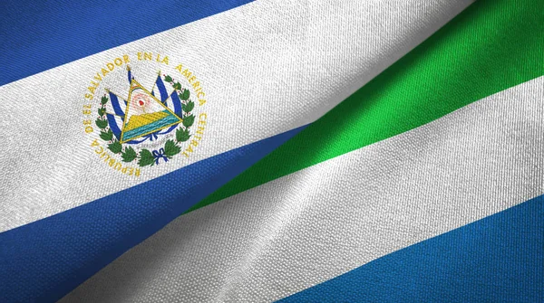 El Salvador e Serra Leoa duas bandeiras de pano têxtil, textura de tecido — Fotografia de Stock