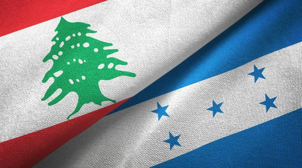 Liban et Honduras deux drapeaux tissu textile, texture du tissu — Photo