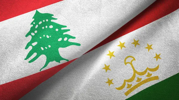 Liban et Tadjikistan deux drapeaux tissu textile, texture du tissu — Photo