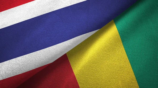 Таиланд и Гвинея два флага текстильная ткань, текстура ткани — стоковое фото