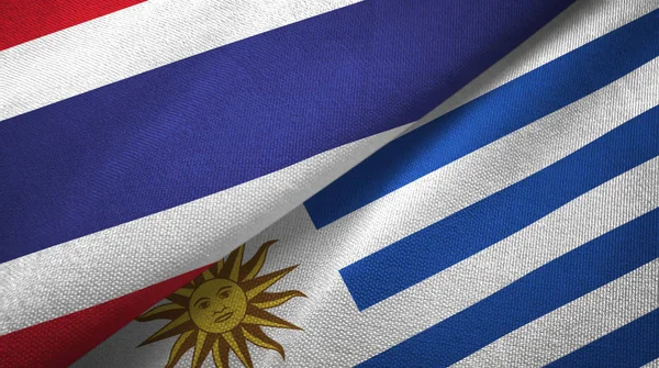 Thailand och Uruguay två flaggor textil trasa, tyg konsistens — Stockfoto