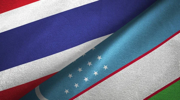 Tailândia e Uzbequistão duas bandeiras de pano têxtil, textura de tecido — Fotografia de Stock