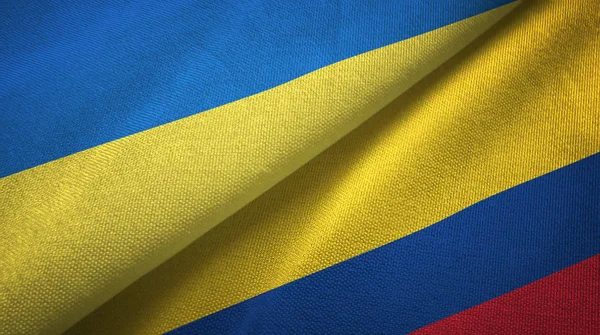 Ucrania y Colombia dos banderas tela textil, textura de la tela —  Fotos de Stock