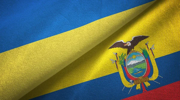 Ukrajna és Ecuador két zászlókat textil ruhával, szövet textúra — Stock Fotó