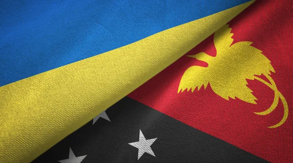 Ucrania y Papúa Nueva Guinea dos banderas tela textil, textura de la tela — Foto de Stock
