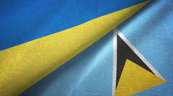 Ukrajna és Saint Lucia két zászló textilszövet, szövet textúra — Stock Fotó