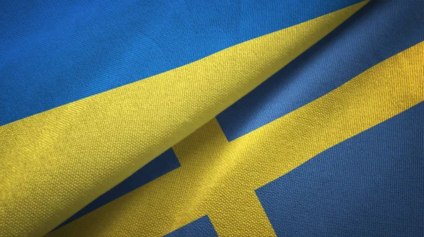 Ucrania y Suecia dos banderas tela textil, textura de la tela —  Fotos de Stock