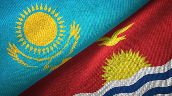 Kazakistan e Kiribati due bandiere tessuto, tessitura del tessuto — Foto Stock