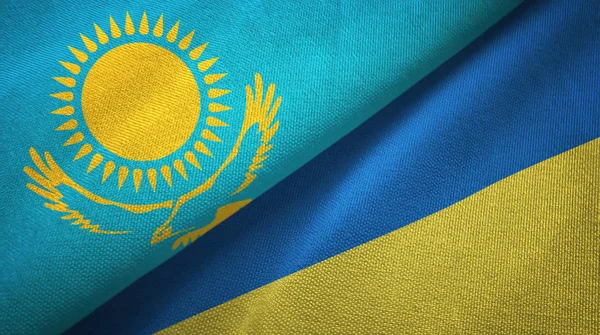 Kazakhstan and Ukraine two flags textile cloth, fabric texture