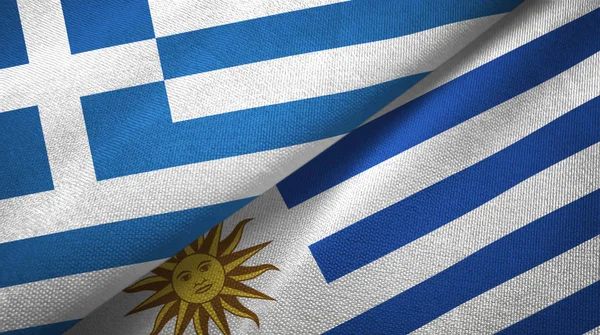 Grekland och Uruguay två flaggor textil trasa, tyg konsistens — Stockfoto