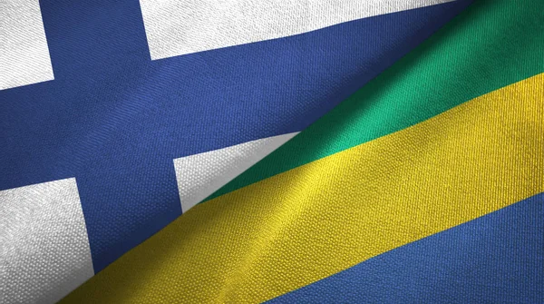 Finlandia y Gabón dos banderas tela textil, textura de la tela —  Fotos de Stock