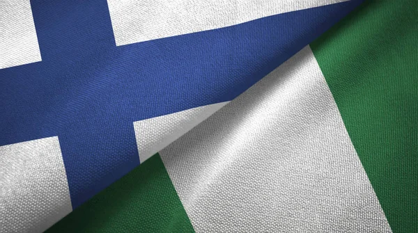 Finlandia e Nigeria due bandiere tessuto, tessitura tessuto — Foto Stock