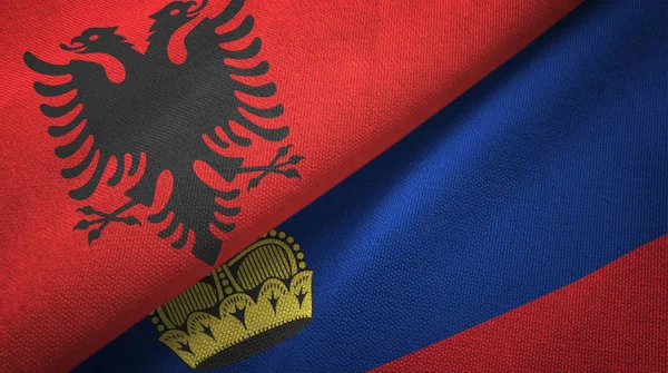 Albanië en Liechtenstein twee vlaggen textiel doek, weefsel textuur — Stockfoto