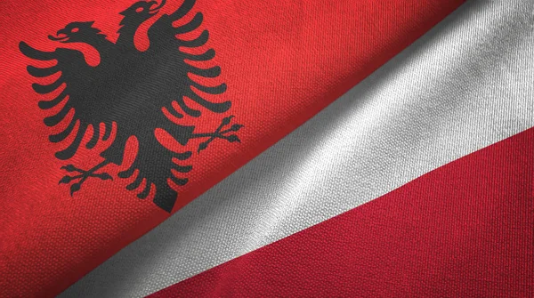 Albania e Polonia due bandiere tessuto, tessitura tessuto — Foto Stock