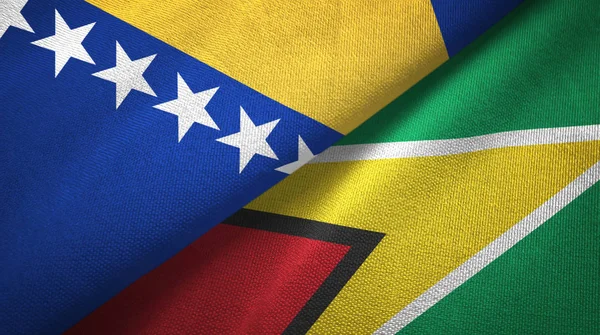 Bosnië en Herzegovina en Guyana twee vlaggen textiel doek, stof textuur — Stockfoto