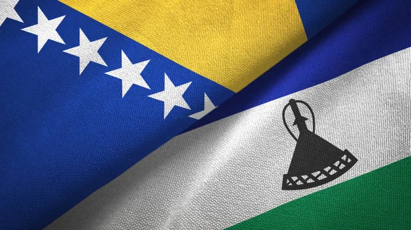 Bosnia y Herzegovina y Lesotho dos banderas tela textil, textura de la tela — Foto de Stock